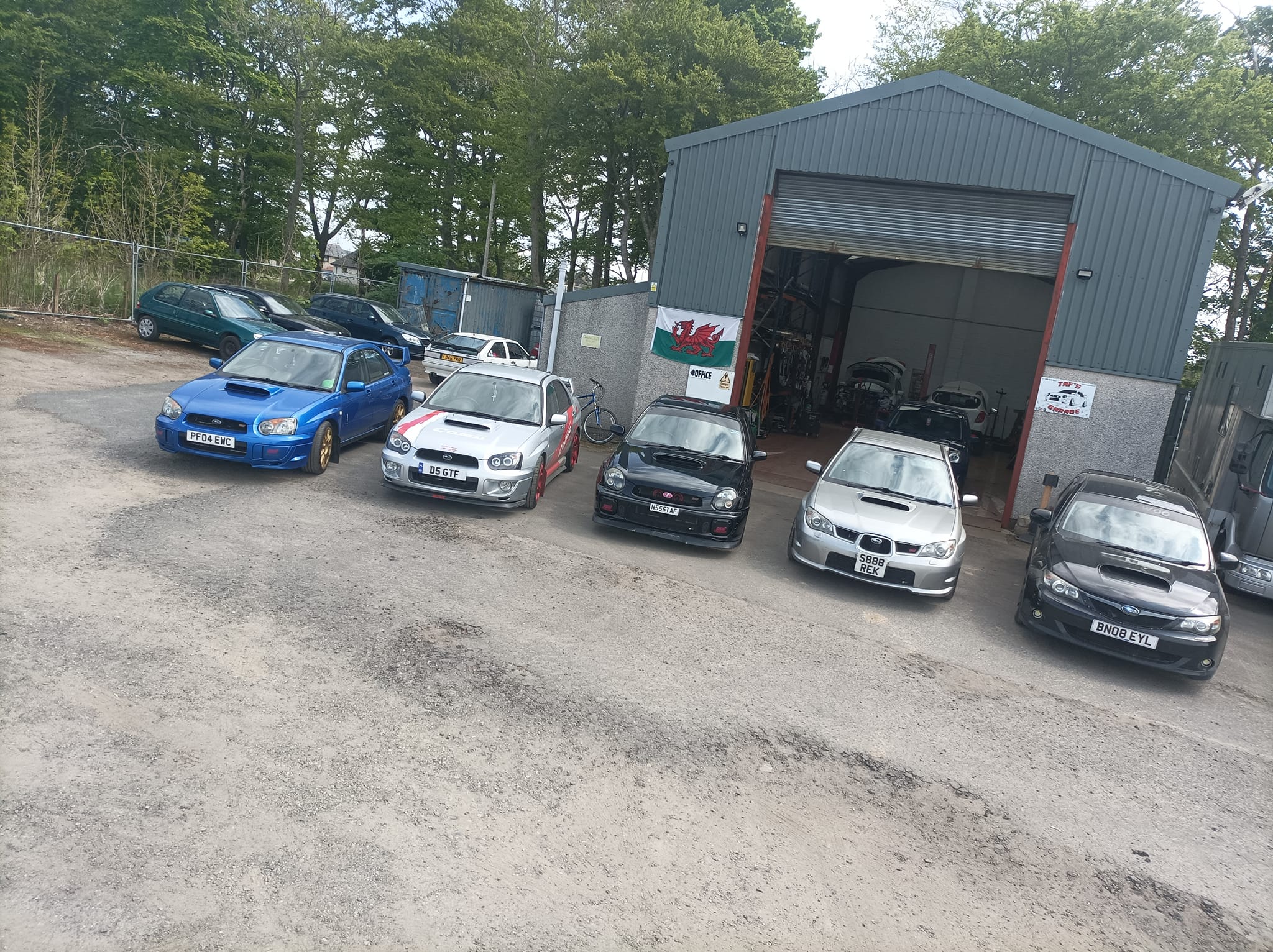 Sports cars parked outside Taf's Garage LTD workshop