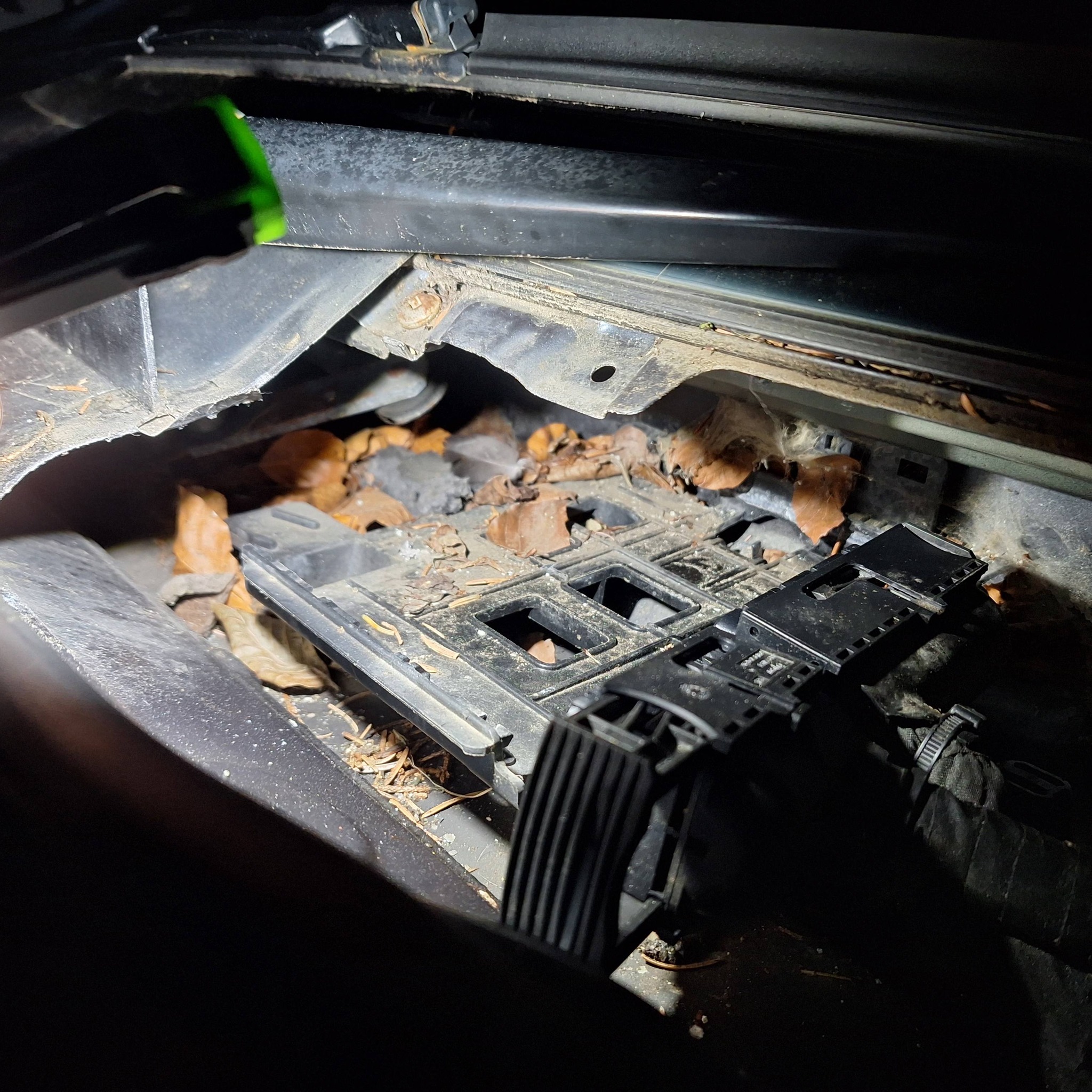 Vehicle engine bay requiring cleaning