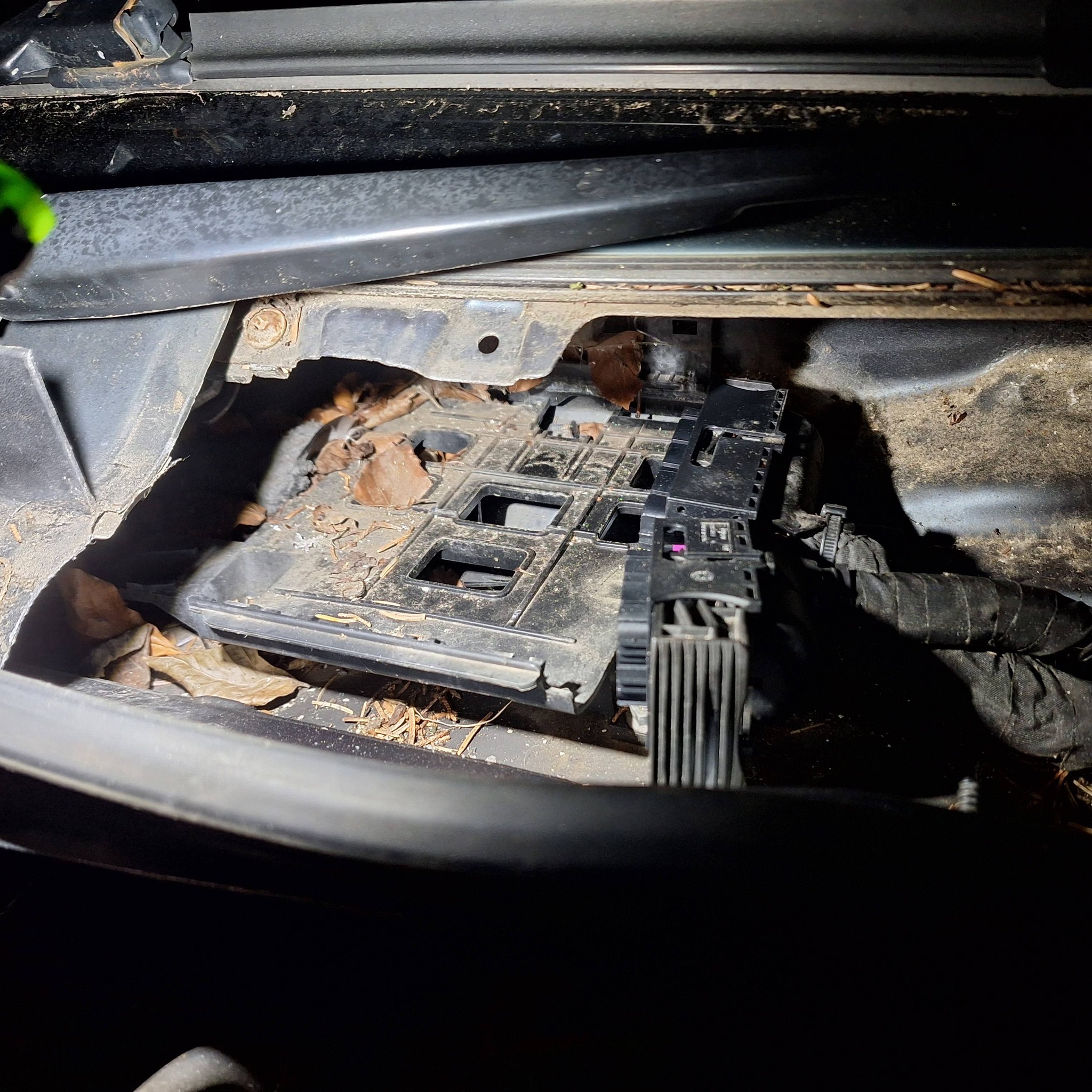 Engine bay with fuse box during repair